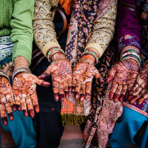Tre coloratissime donne indiane mostrano i loro tatuaggi all'henné (Agra, India 2012)